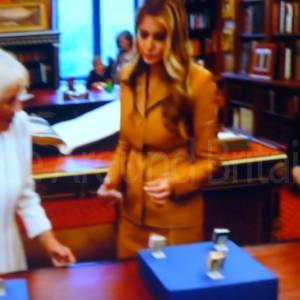 Inspecting miniature books for Queen Mary's doll house